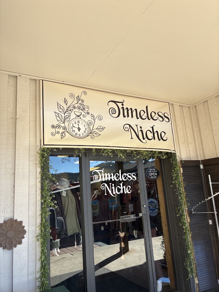 Timeless Niche entrance with hand-lettered sign and greenery